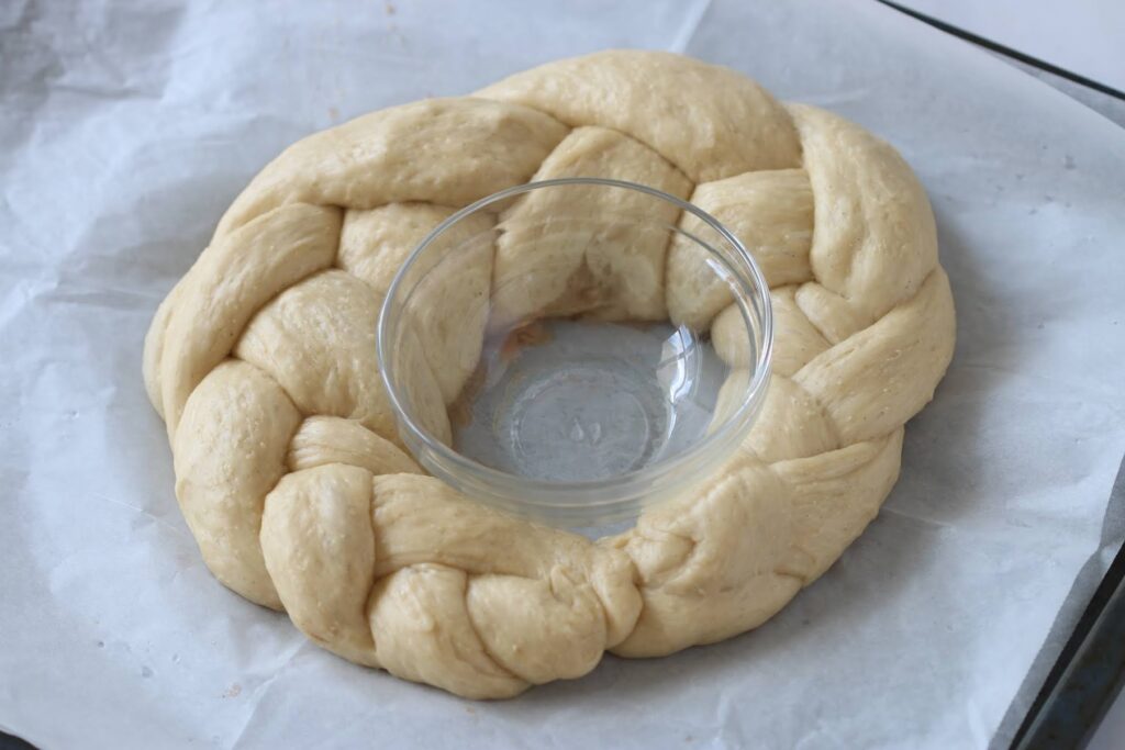braided round challah before baking