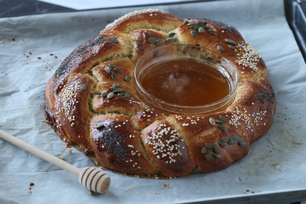 rosh hashanah challah with honey bowl in the middle
