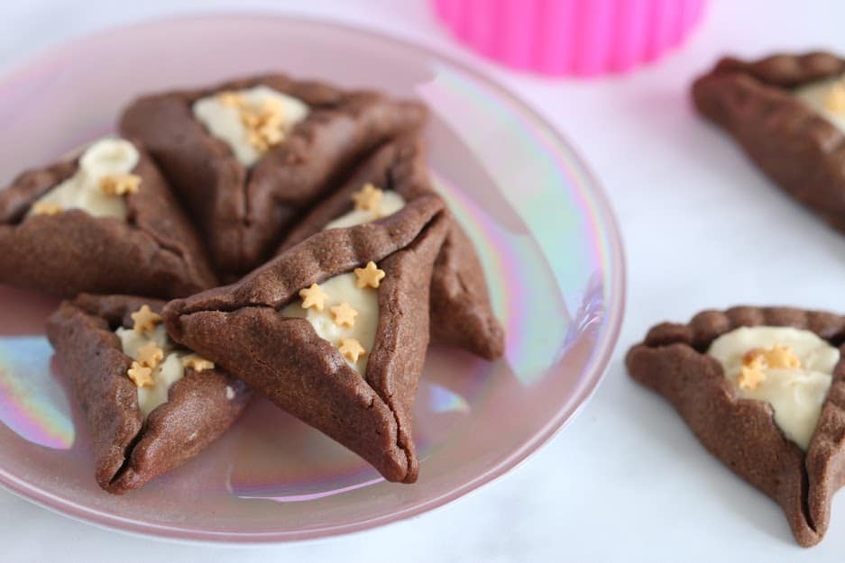 chocolate hamantaschen cookies on a plate