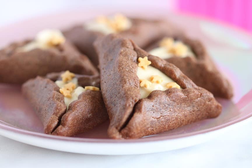 chocolate hamantaschen cookies on a plate