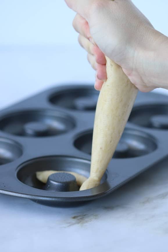 hand piping batter to donuts pan