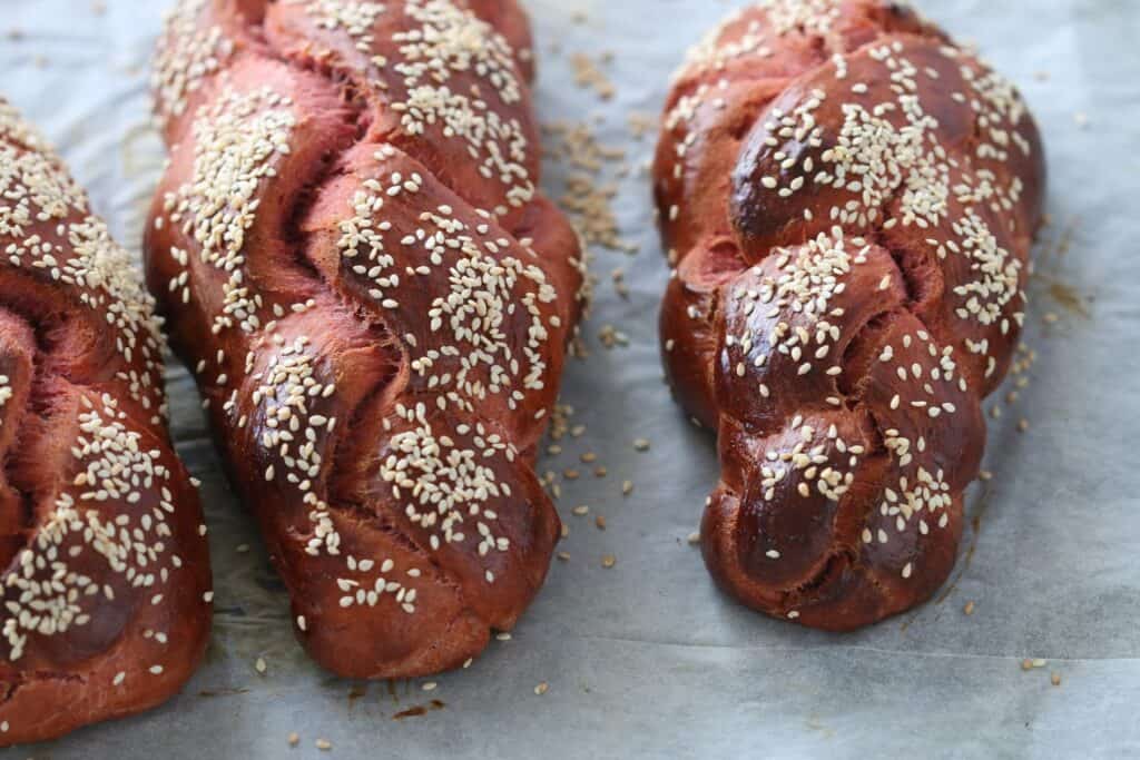 3 Beet challah breads on a a pan