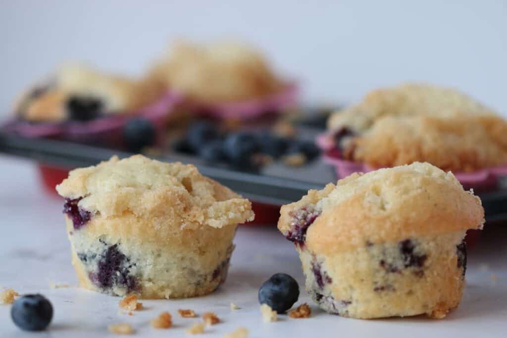 blueberry muffins in a pan and near it