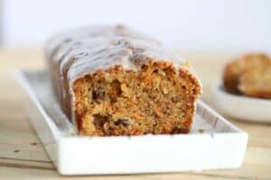 cut carrot cake loaf on a platter