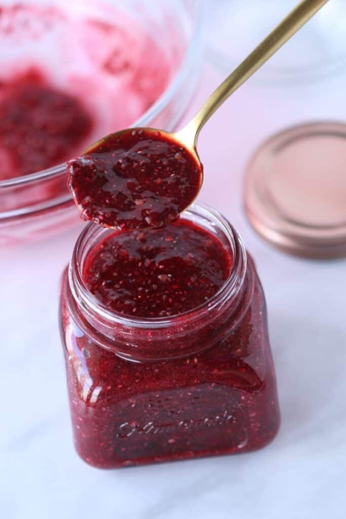 strawberry chia jam in a jar and on a tablespoon