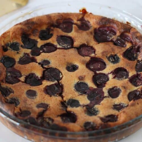 gluten free cherry clafoutis cake in a round pan