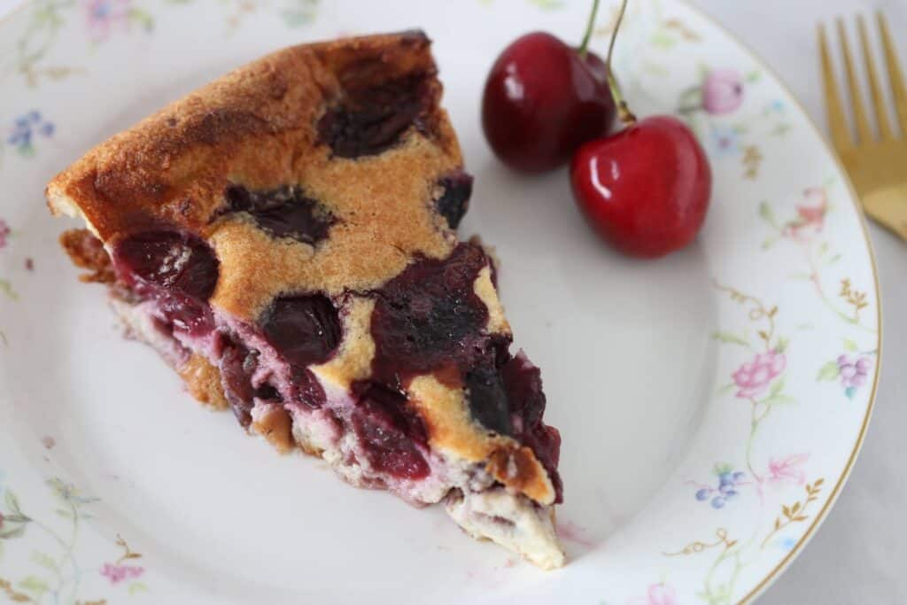 cherry clafoutis slice on a plate