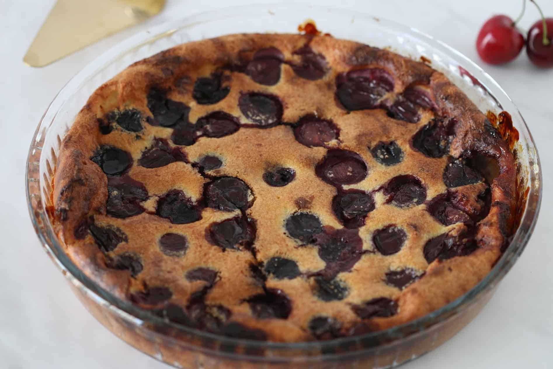 gluten free cherry clafoutis cake in a round pan