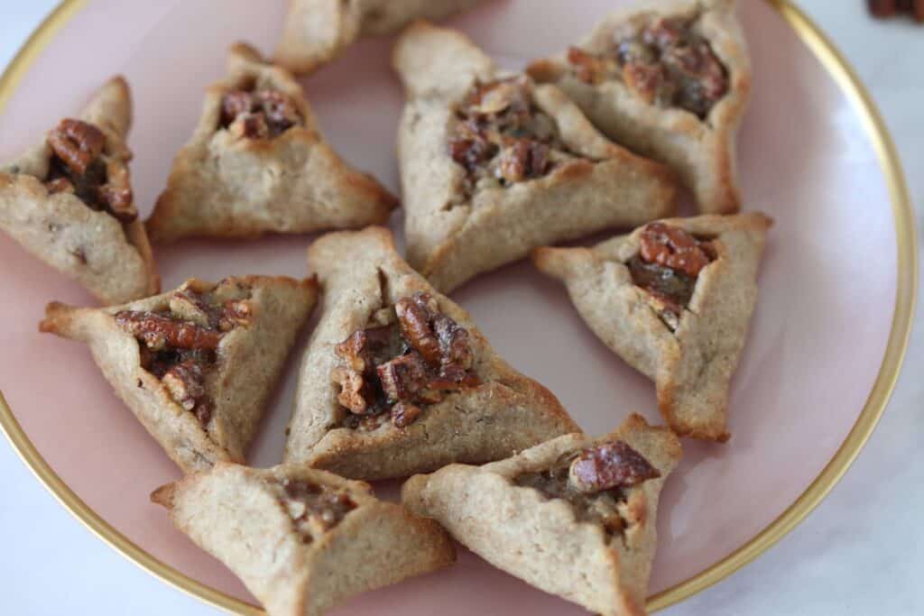 Pecan Pie Hamantaschen cookies on a pink plate