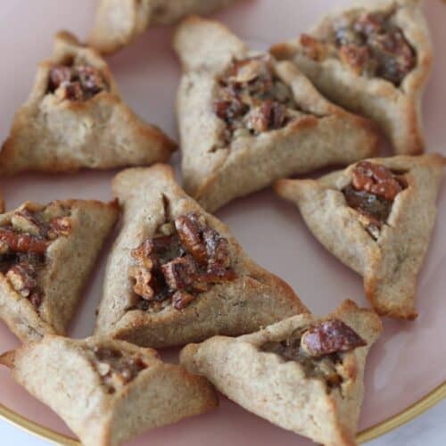 Pecan Pie Hamantaschen cookies on a pink plate