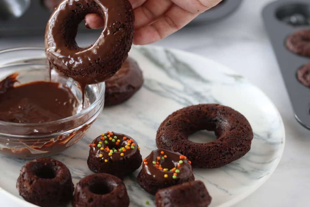 dipping donut to melted chocolate