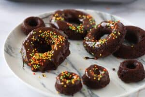 Vegan Chocolate Zucchini Baked Donuts on a marble plate