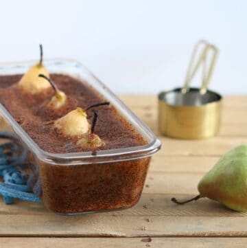 Vegan Maple Whole Pear Cake in a pan on a wood surface