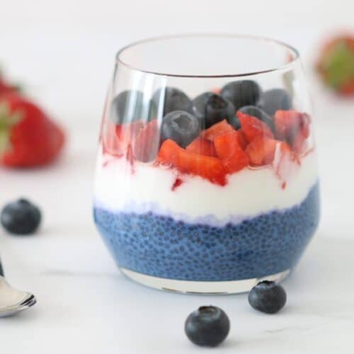 layered chia pudding in a cup with Greek yogurt and berries
