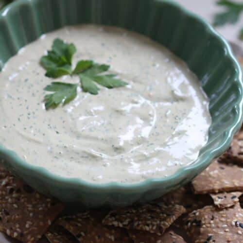 green tahini dip in a bowl